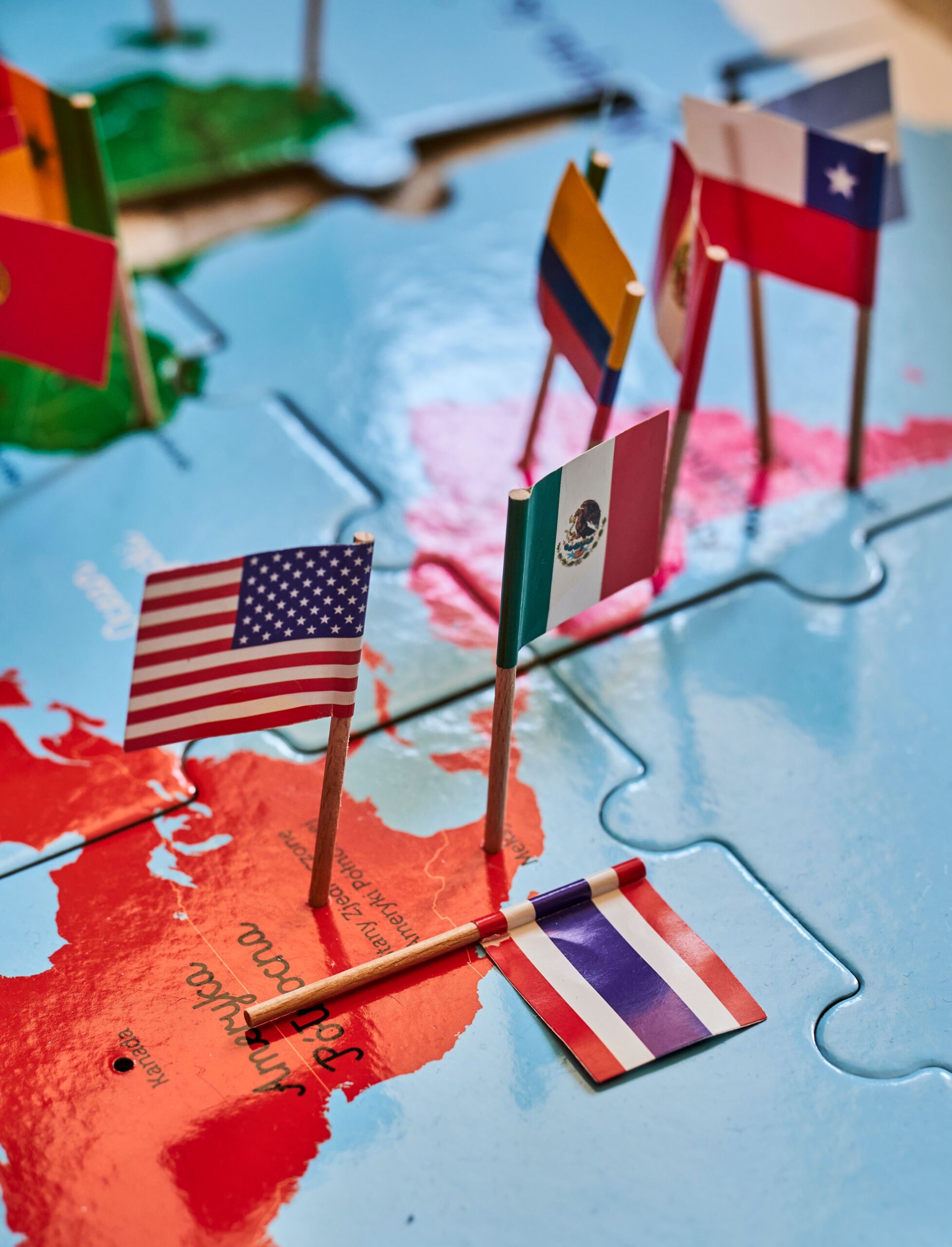 Vertical shot of the United States and Mexican flag on a puzzle map